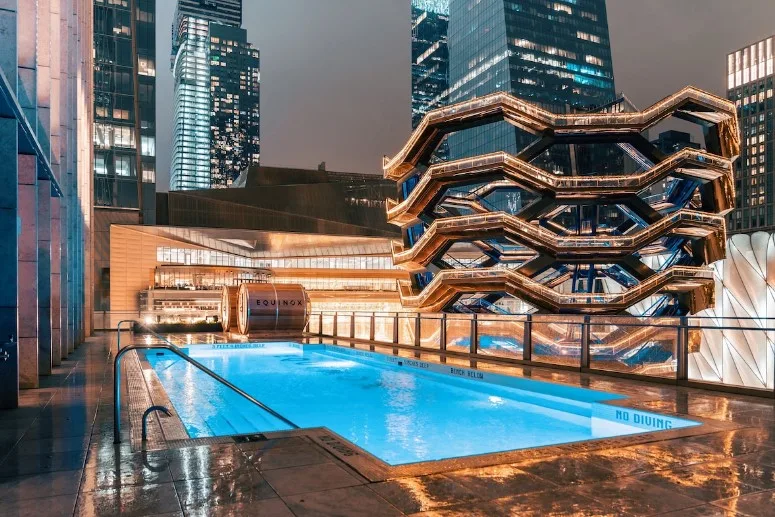 View of the rooftop pool at Equinox Hotel, a hotel with an indoor pool in NYC and a rooftop pool.