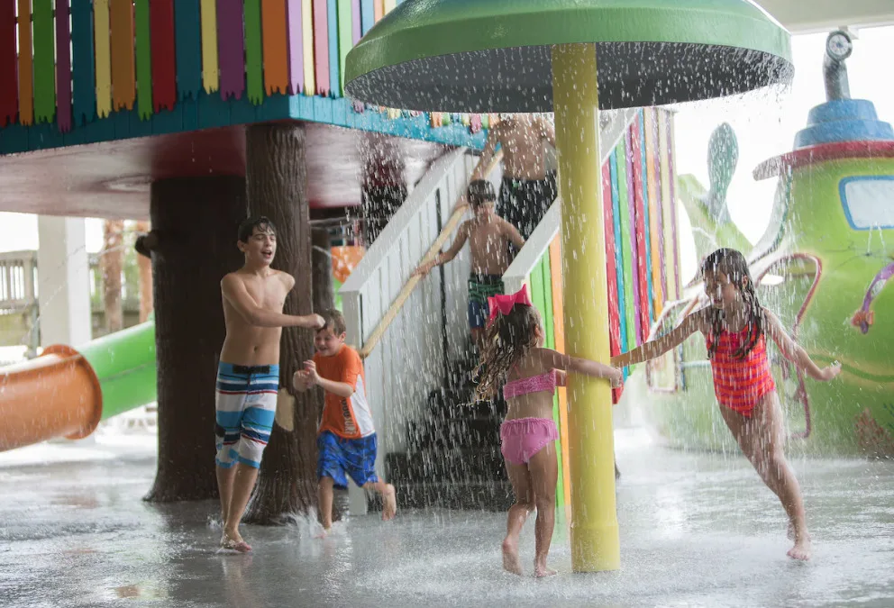 Myrtle Beach hotels with indoor pools and water parks Crown Reef Beach Resort and Waterpark kids playing indoor water feature and fountain