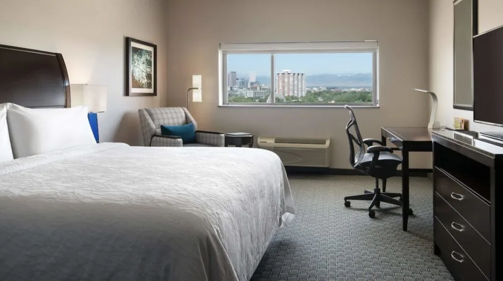 hotel room with a large window and mountain view at Hilton Garden Inn Denver/Cherry Creek Colorado