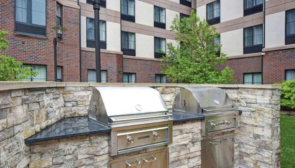 outdoor social space with BBQ grill at Homewood Suites by Hilton Denver International Airport